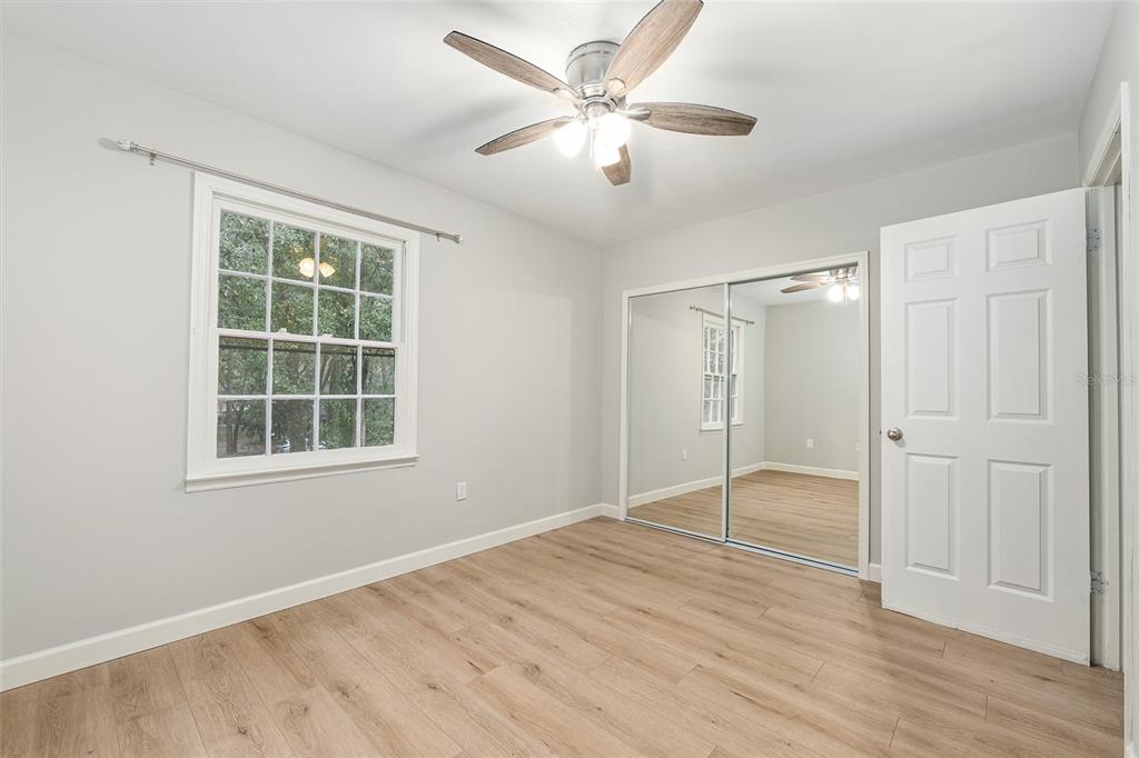 5240 Southwest 92nd Court Gainesville, FL 32608 - Photo 41 of 58 an empty room with wooden floor and windows