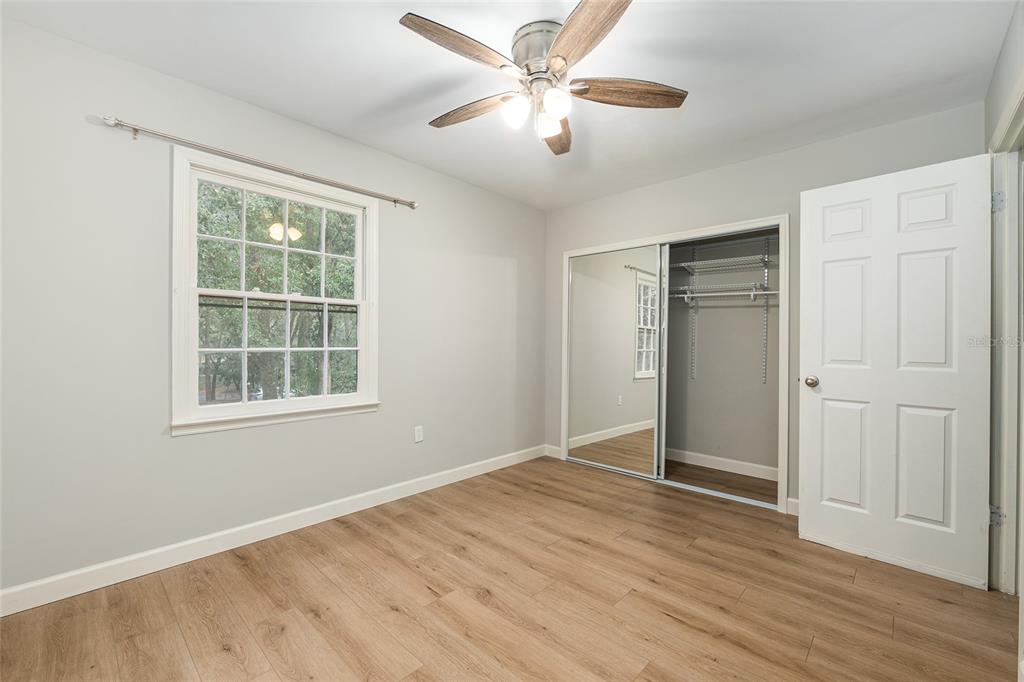 5240 Southwest 92nd Court Gainesville, FL 32608 - Photo 42 of 58 a view of an empty room with a window and wooden floor
