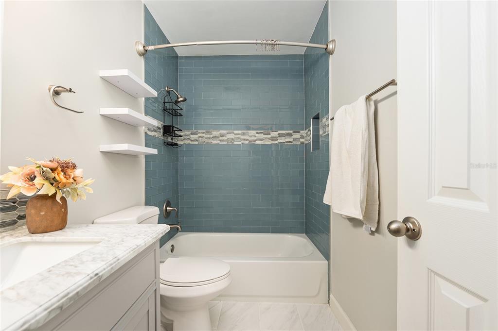 5240 Southwest 92nd Court Gainesville, FL 32608 - Photo 44 of 58 a bathroom with a granite countertop sink toilet and shower