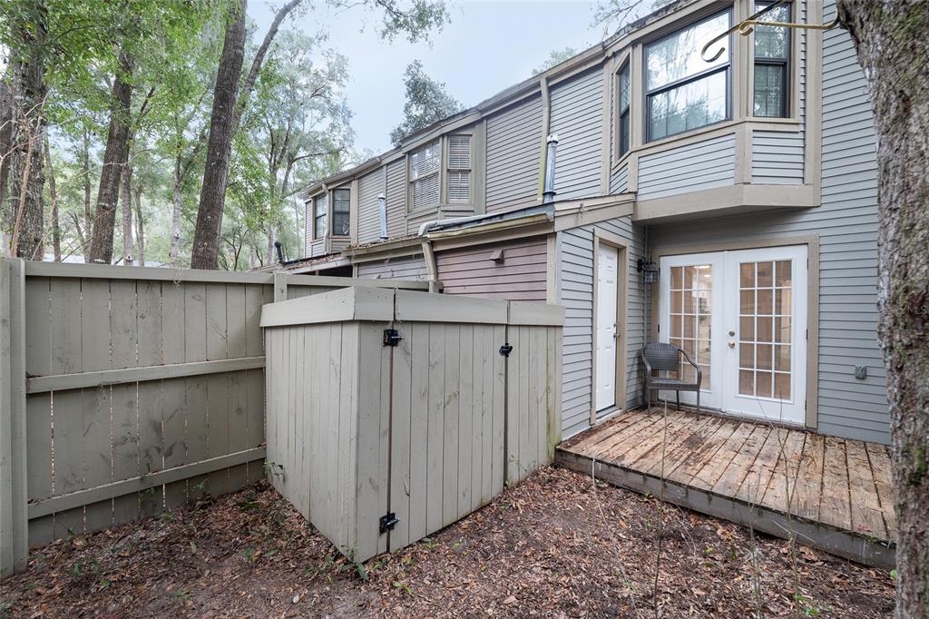 5240 Southwest 92nd Court Gainesville, FL 32608 - Photo 51 of 58 a view of a house with a large window and wooden fence