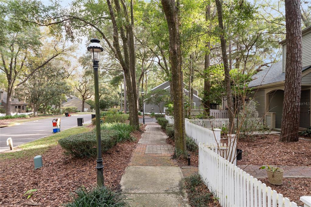 5240 Southwest 92nd Court Gainesville, FL 32608 - Photo 6 of 58 a view of a pathway with a wrought fence