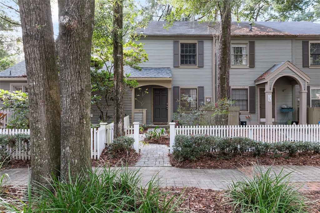 5240 Southwest 92nd Court Gainesville, FL 32608 - Photo 7 of 58 a front view of a house with yard and porch