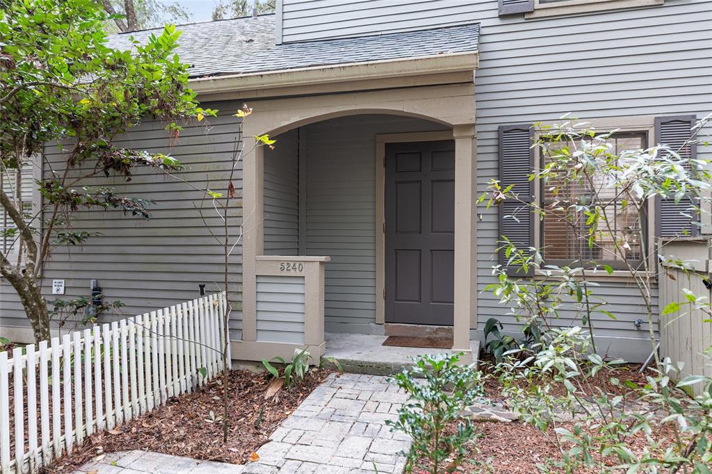 5240 Southwest 92nd Court Gainesville, FL 32608 - Photo 10 of 58 a front view of a house with a garden