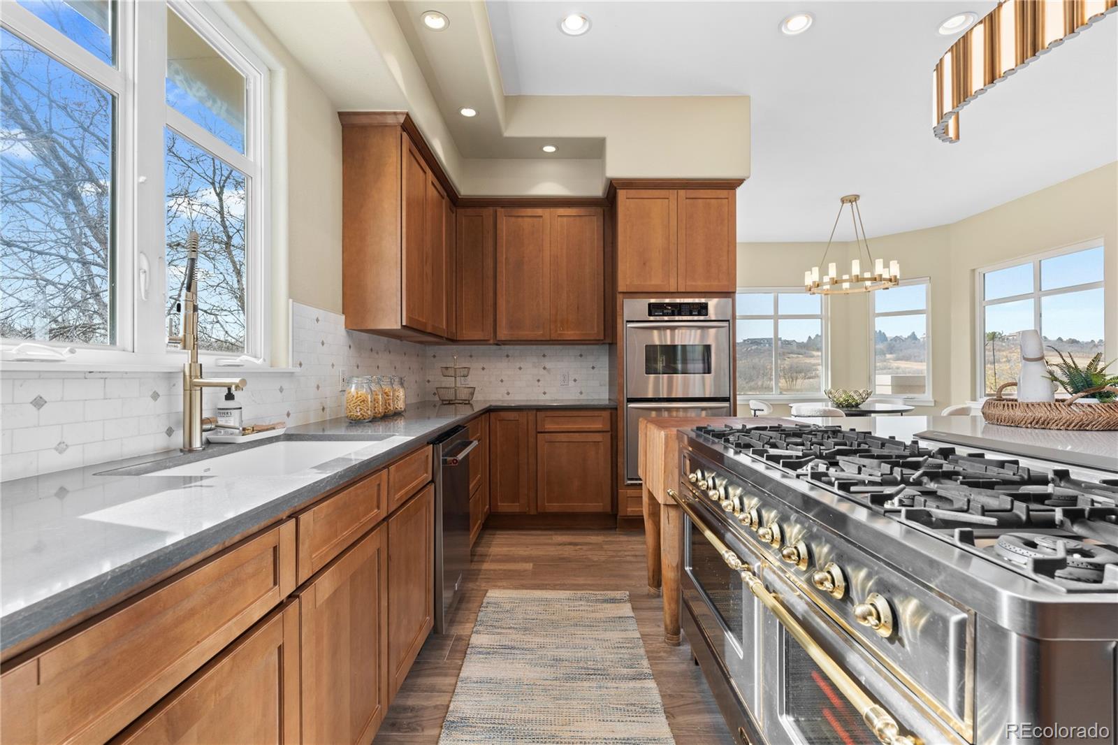 6329 Diamond Ridge Parkway Castle Rock, CO 80108 - Photo 13 of 47 a kitchen with stainless steel appliances a sink stove and cabinets