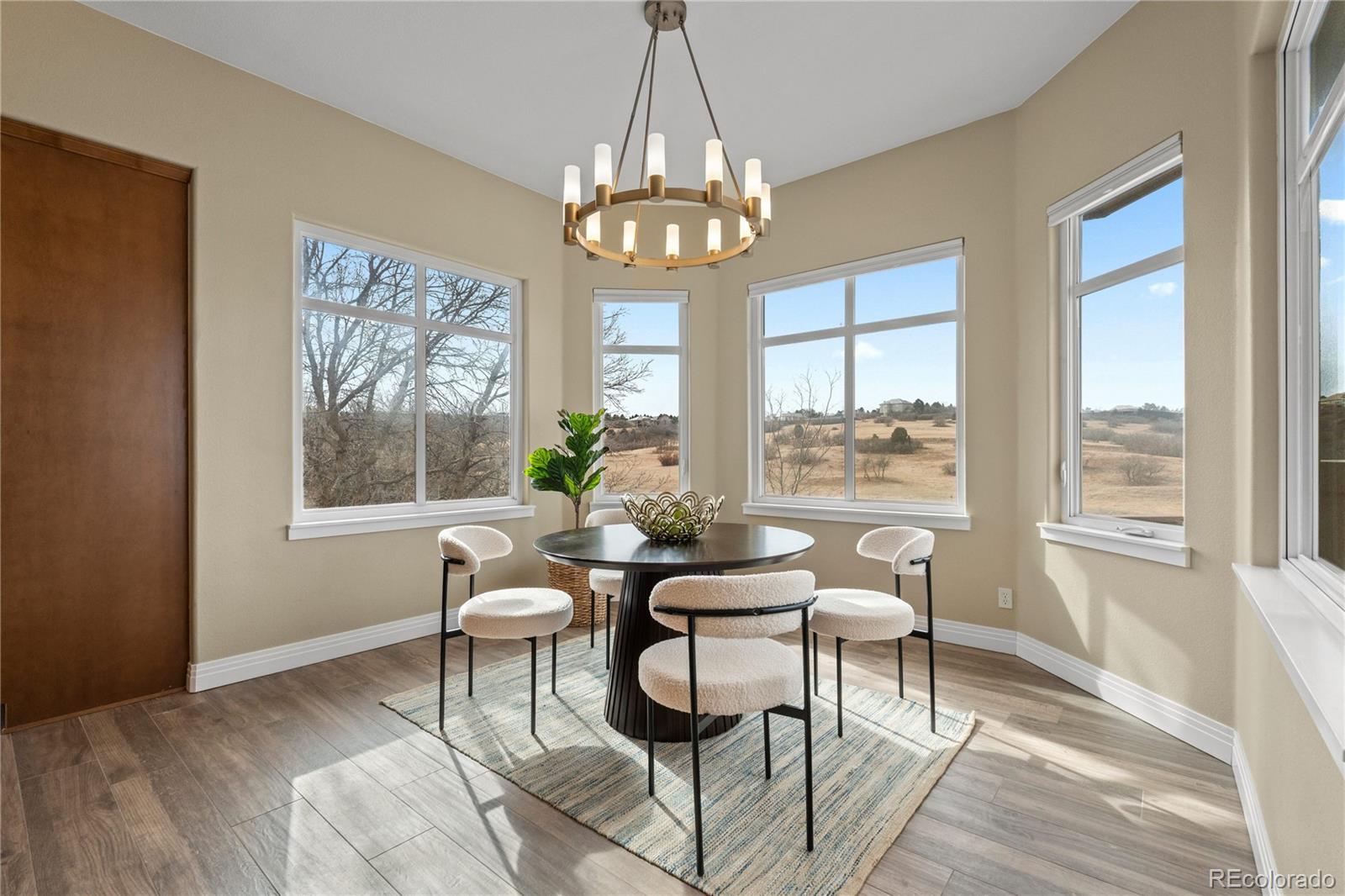 6329 Diamond Ridge Parkway Castle Rock, CO 80108 - Photo 14 of 47 a view of a dining room with furniture wooden floor and a chandelier