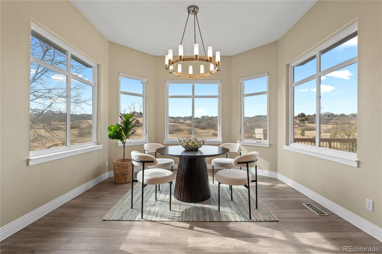 6329 Diamond Ridge Parkway Castle Rock, CO 80108 - Photo 15 of 47 a dining room with wooden floor and a chandelier