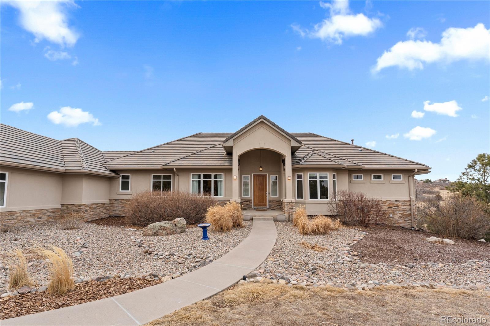 6329 Diamond Ridge Parkway Castle Rock, CO 80108 - Photo 2 of 47 a front view of a house with a yard