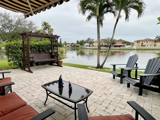 a view of a bench in the garden near a lake