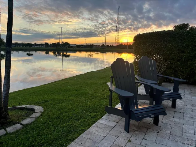 a view of a backyard with plants and lake view