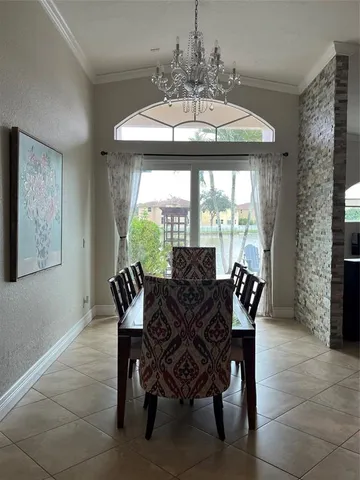 a kitchen with stainless steel appliances granite countertop a sink and a living room view