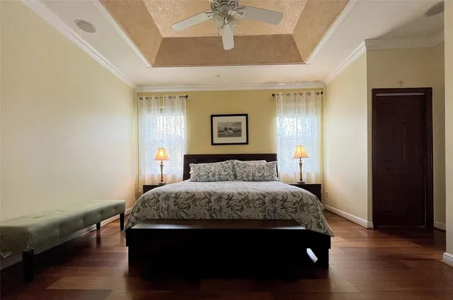 a bedroom with a large bed and a chandelier