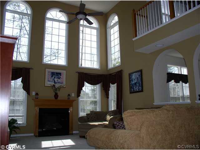 11843 Club Ridge Drive Chester, VA 23836 - Photo 8 of 12 a living room with furniture and a fireplace