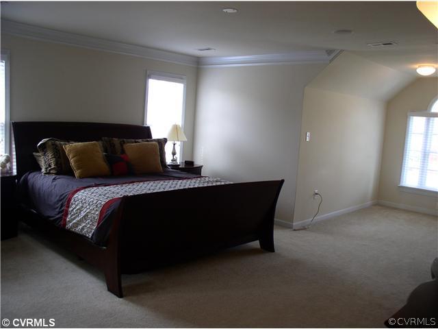 11843 Club Ridge Drive Chester, VA 23836 - Photo 9 of 12 a bed sitting in a bedroom next to a window