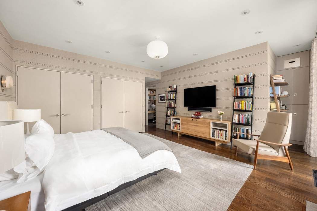 433 East 74th Street, Unit 4A Manhattan, NY 10021 - Photo 13 of 34 a bedroom with furniture and a flat screen tv