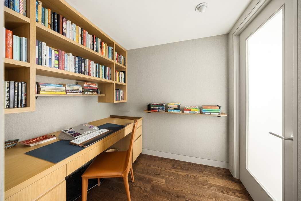 433 East 74th Street, Unit 4A Manhattan, NY 10021 - Photo 16 of 34 a workspace with furniture and a book shelf