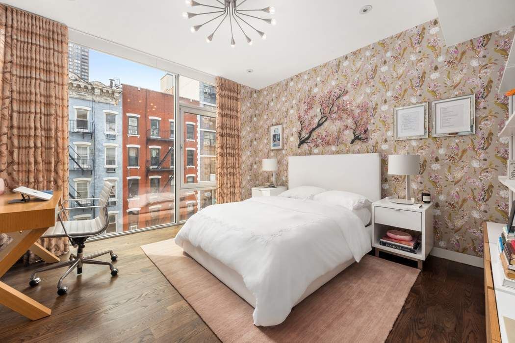 433 East 74th Street, Unit 4A Manhattan, NY 10021 - Photo 20 of 34 a large bed sitting in a room next to a window