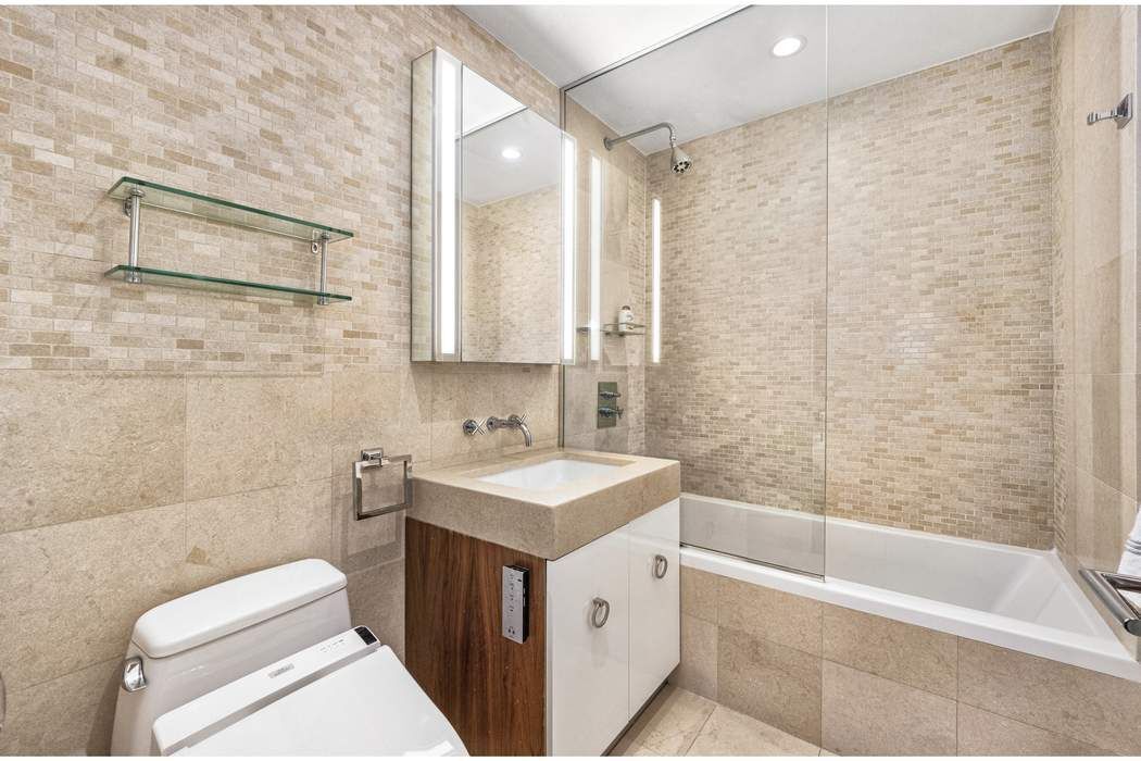 433 East 74th Street, Unit 4A Manhattan, NY 10021 - Photo 25 of 34 a bathroom with a sink a toilet and a bathtub