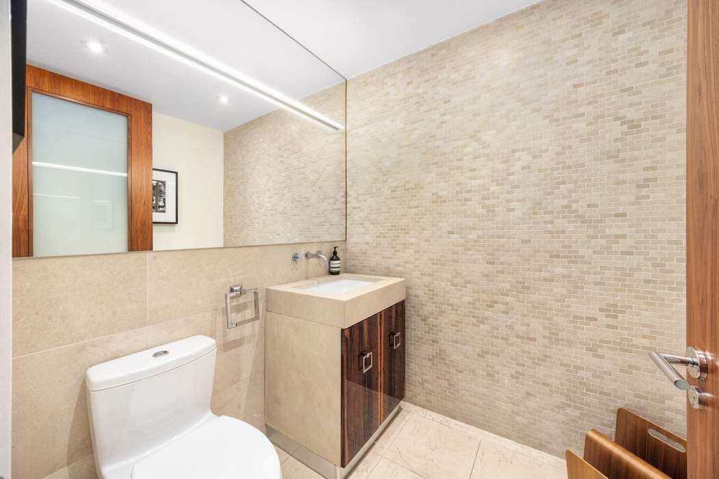 433 East 74th Street, Unit 4A Manhattan, NY 10021 - Photo 30 of 34 a bathroom with a toilet sink and mirror