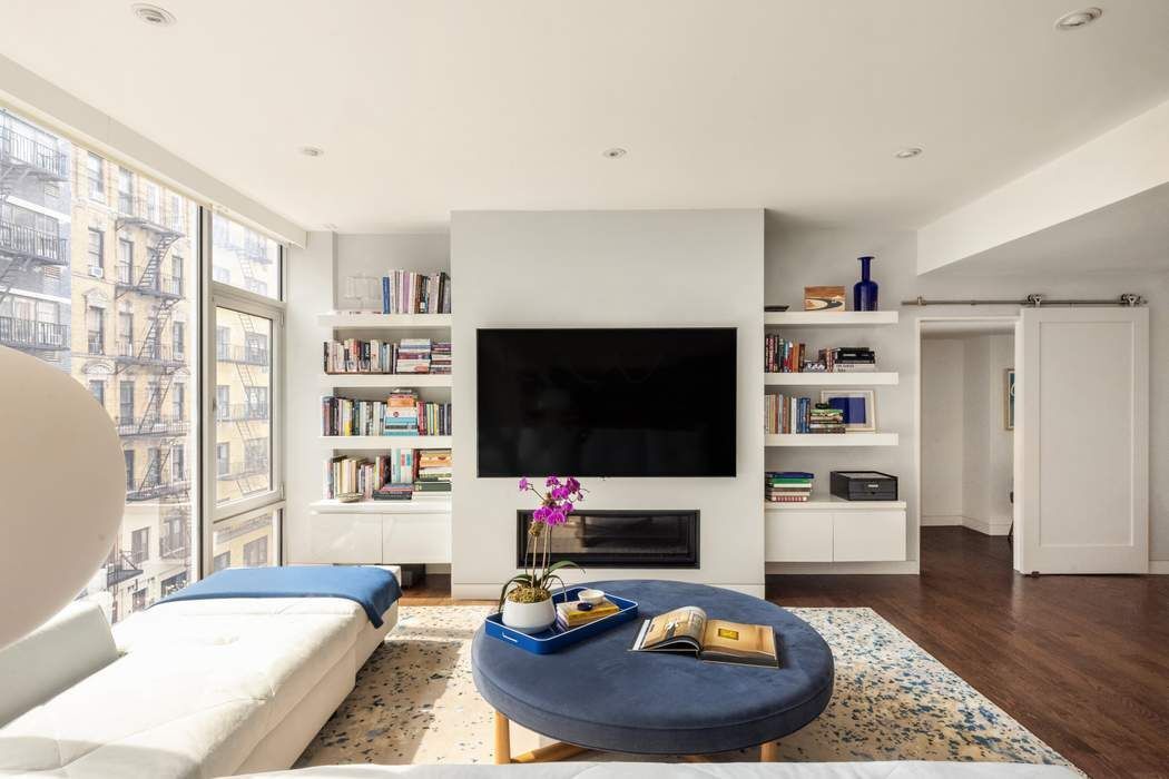 433 East 74th Street, Unit 4A Manhattan, NY 10021 - Photo 3 of 34 a living room with furniture and a flat screen tv