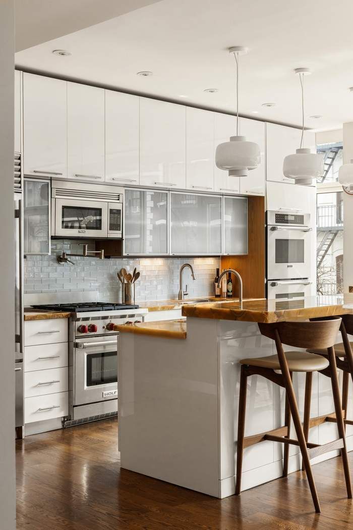433 East 74th Street, Unit 4A Manhattan, NY 10021 - Photo 6 of 34 a kitchen with stainless steel appliances granite countertop a stove top oven a sink a counter space and cabinets