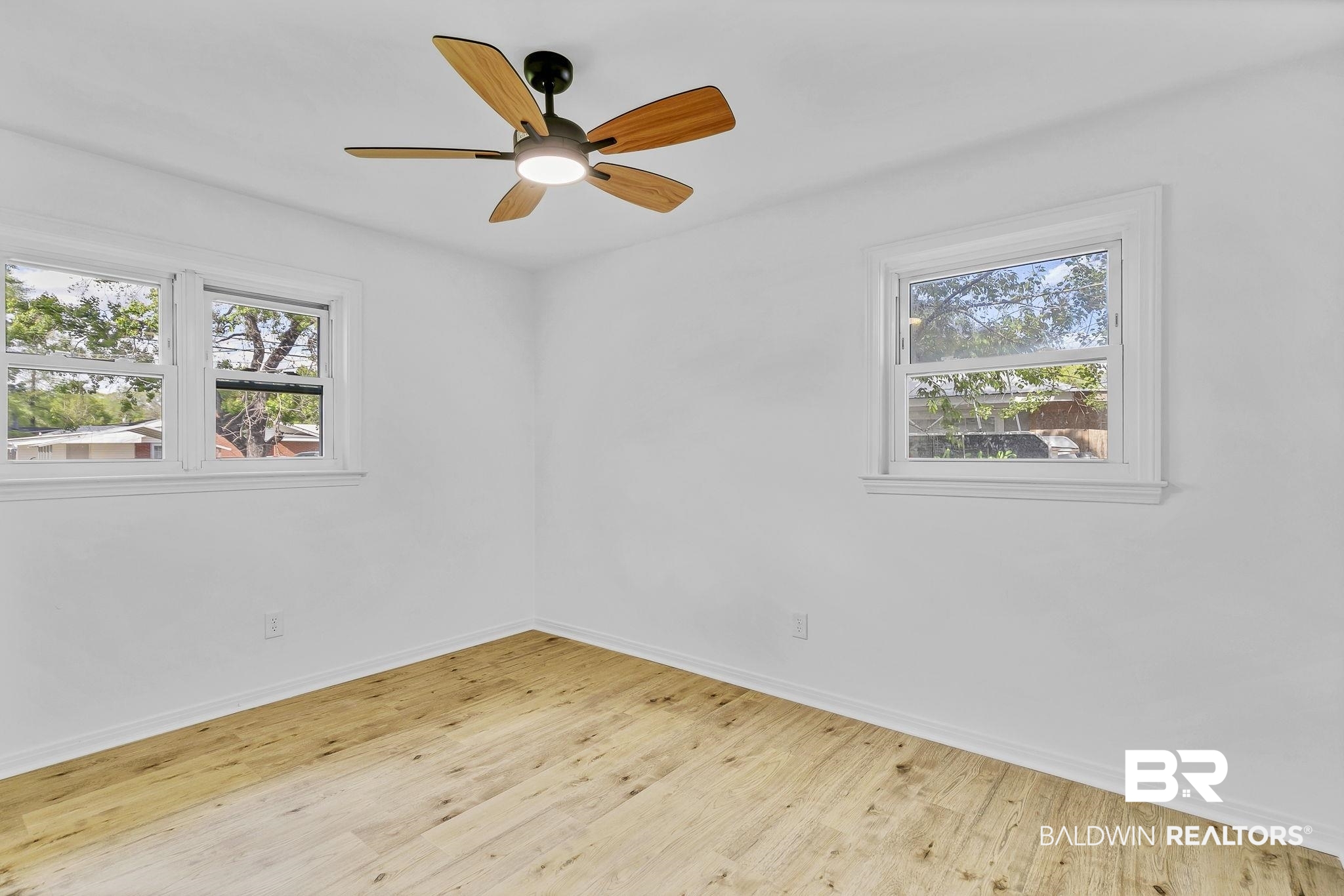 203 Anderson Road Saraland, AL 36571 - Photo 29 of 48 Spare room featuring a wealth of natural light, baseboards, and wood finished floors