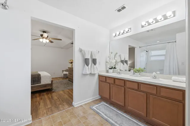 a front view of a house with a yard and potted plants