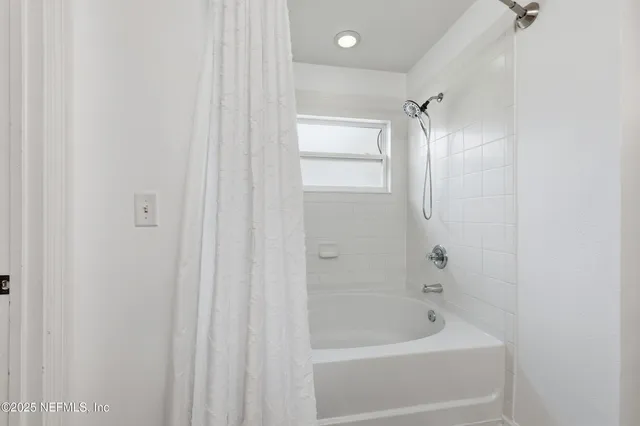 an aerial view of residential houses with outdoor space and swimming pool