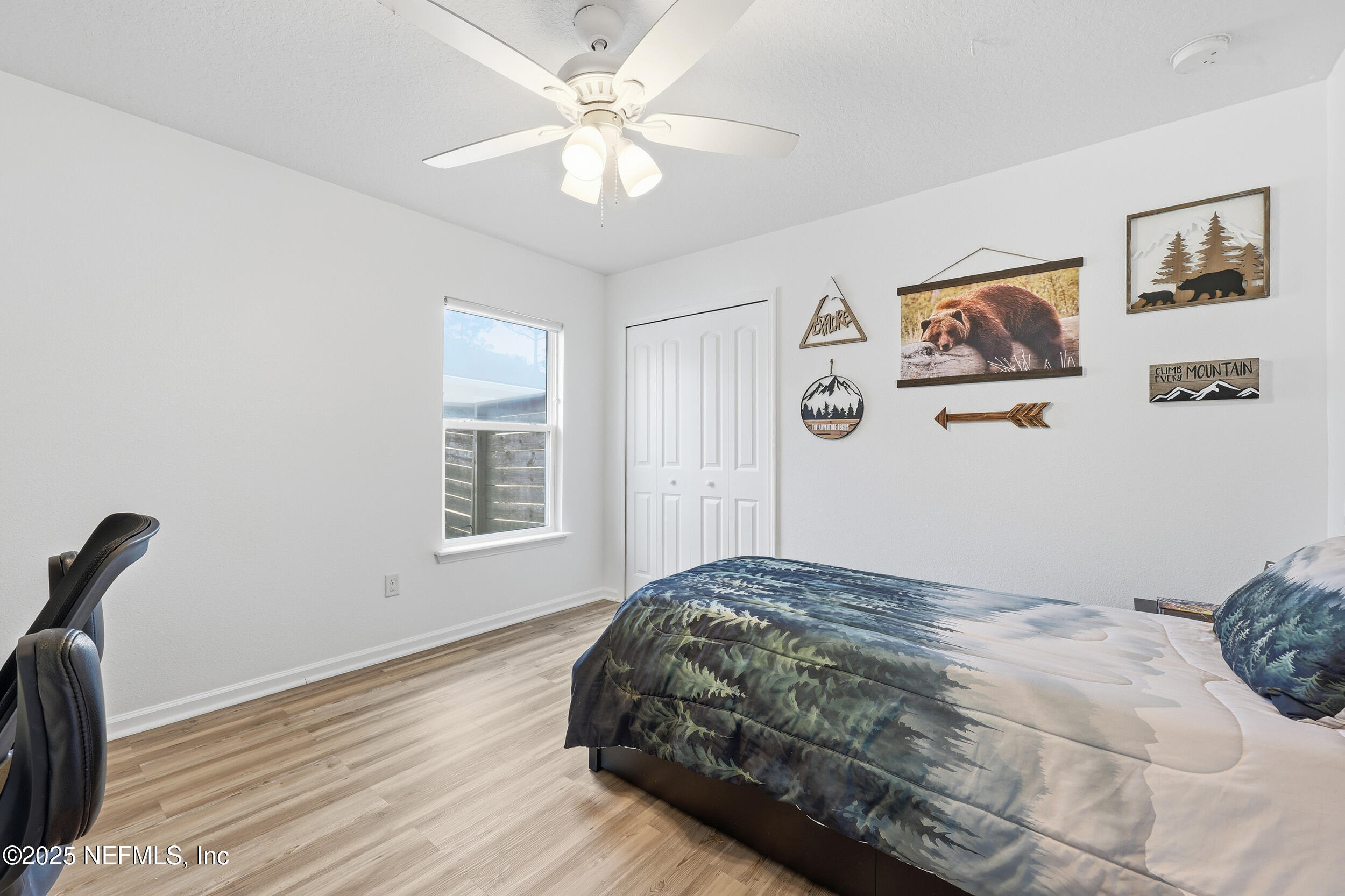 131 North Twin Maple Road St. Augustine, FL 32084 - Photo 27 of 55 a bedroom with a large bed and a chandelier