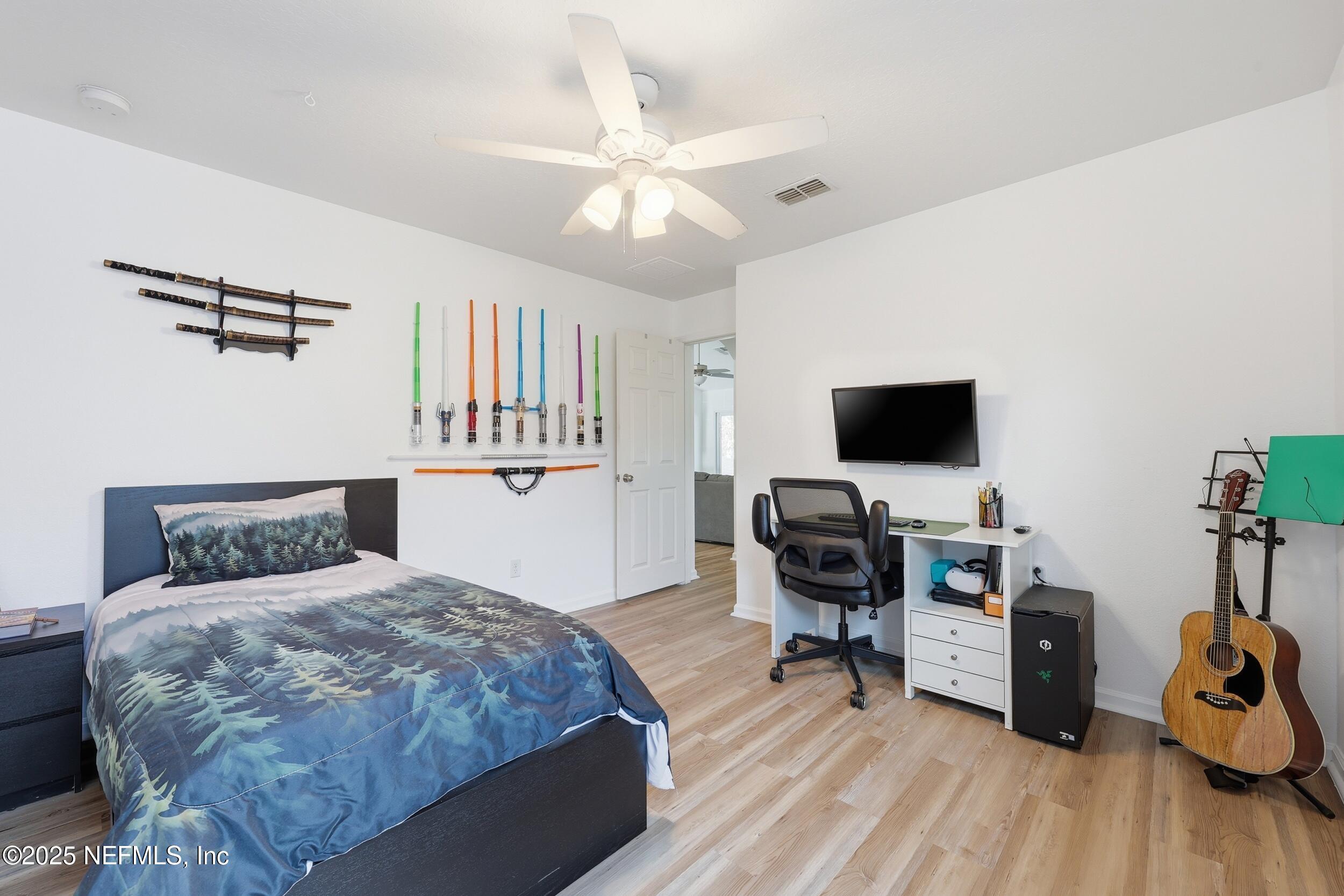 131 North Twin Maple Road St. Augustine, FL 32084 - Photo 29 of 55 a bedroom with a bed and a flat screen tv