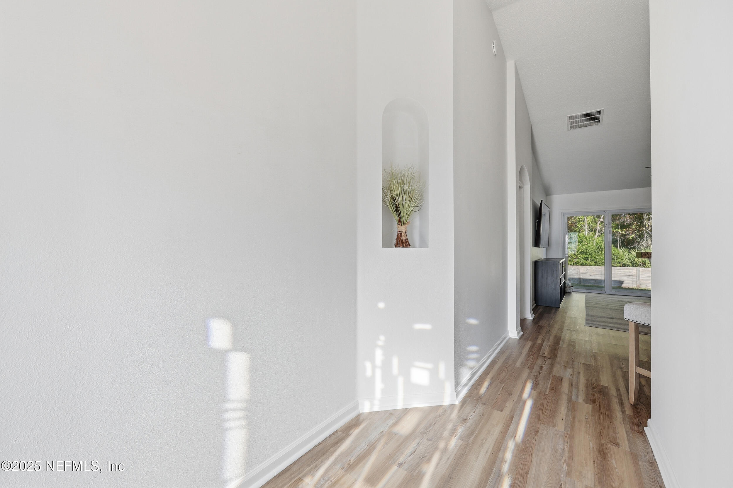 131 North Twin Maple Road St. Augustine, FL 32084 - Photo 35 of 55 a view of a hallway with wooden floor and a living room