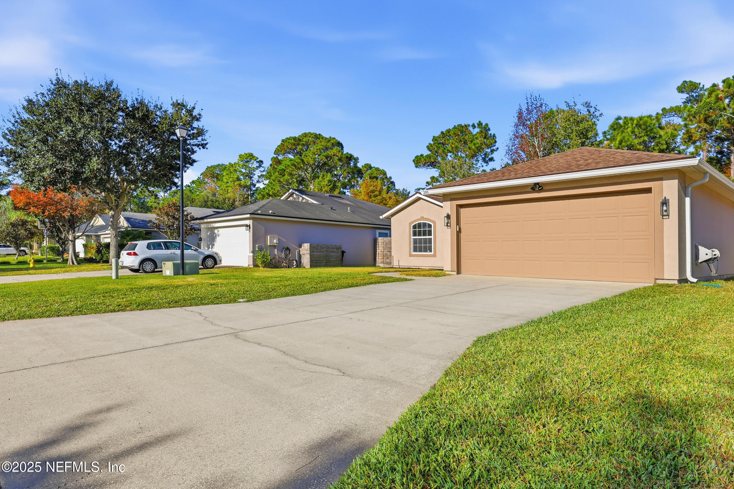 131 North Twin Maple Road St. Augustine, FL 32084 - Photo 42 of 55 a front view of a house with a yard and potted plants