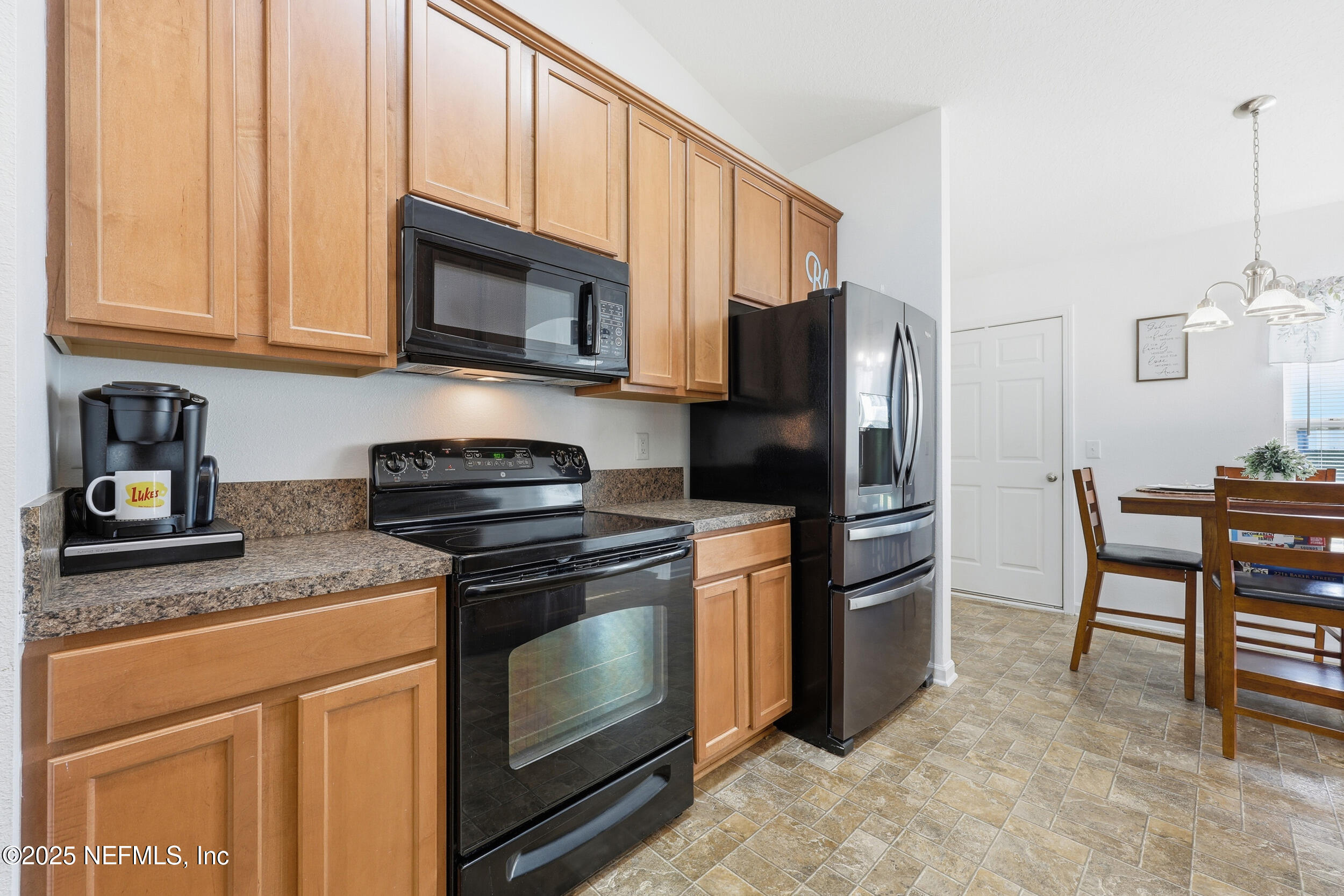 131 North Twin Maple Road St. Augustine, FL 32084 - Photo 9 of 55 a kitchen with stainless steel appliances granite countertop a stove a refrigerator and a microwave