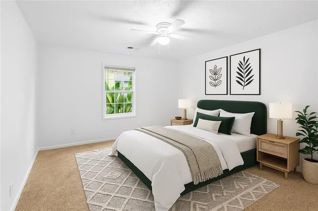 a bedroom with a bed and a painting on the wall