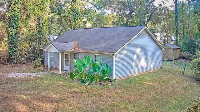 a view of a house with a yard and plants