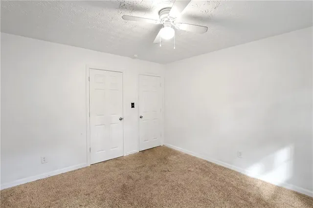 a view of a big room with carpet
