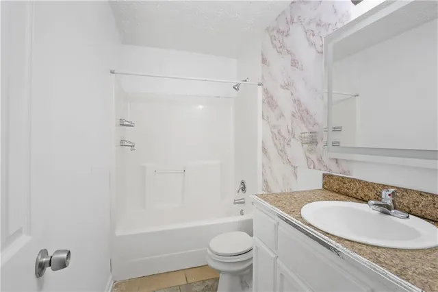 a bathroom with a sink a toilet and a bathtub