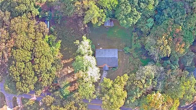 an aerial view of a house with a yard and garden