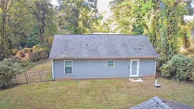 a house that has a tree in front of it