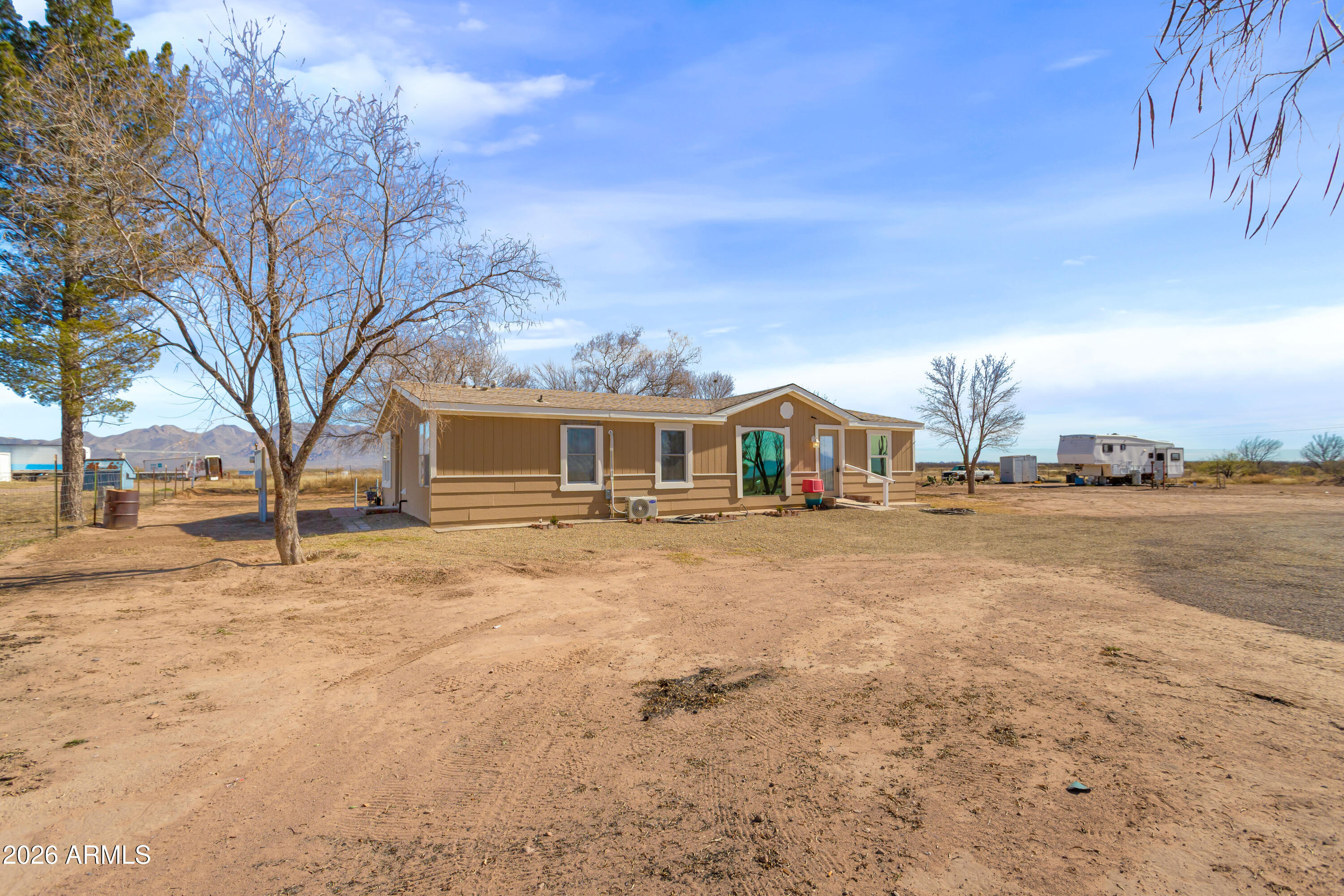 10405 North Mormon Road Elfrida, AZ 85610 - Photo 29 of 43 a front view of a house with a yard and garage