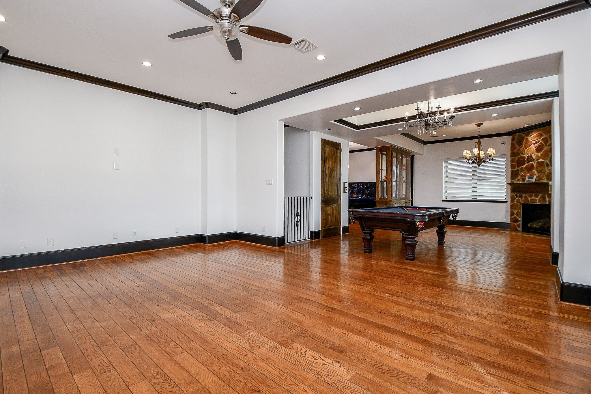 4119 Allen Street Houston, TX 77007 - Photo 33 of 50 a view of an empty room with wooden floor and a ceiling fan