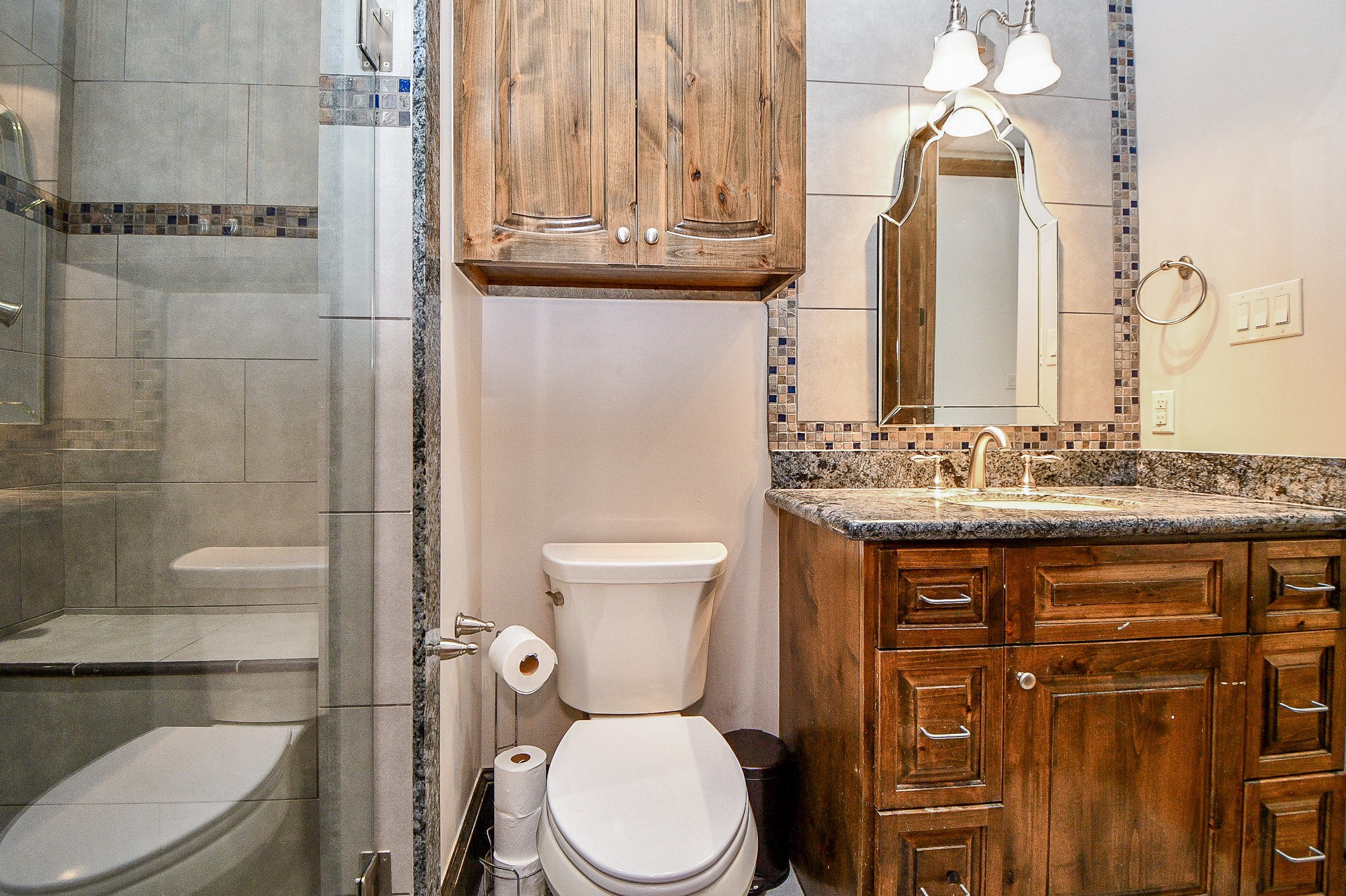 4119 Allen Street Houston, TX 77007 - Photo 37 of 50 a bathroom with a granite countertop toilet sink and mirror