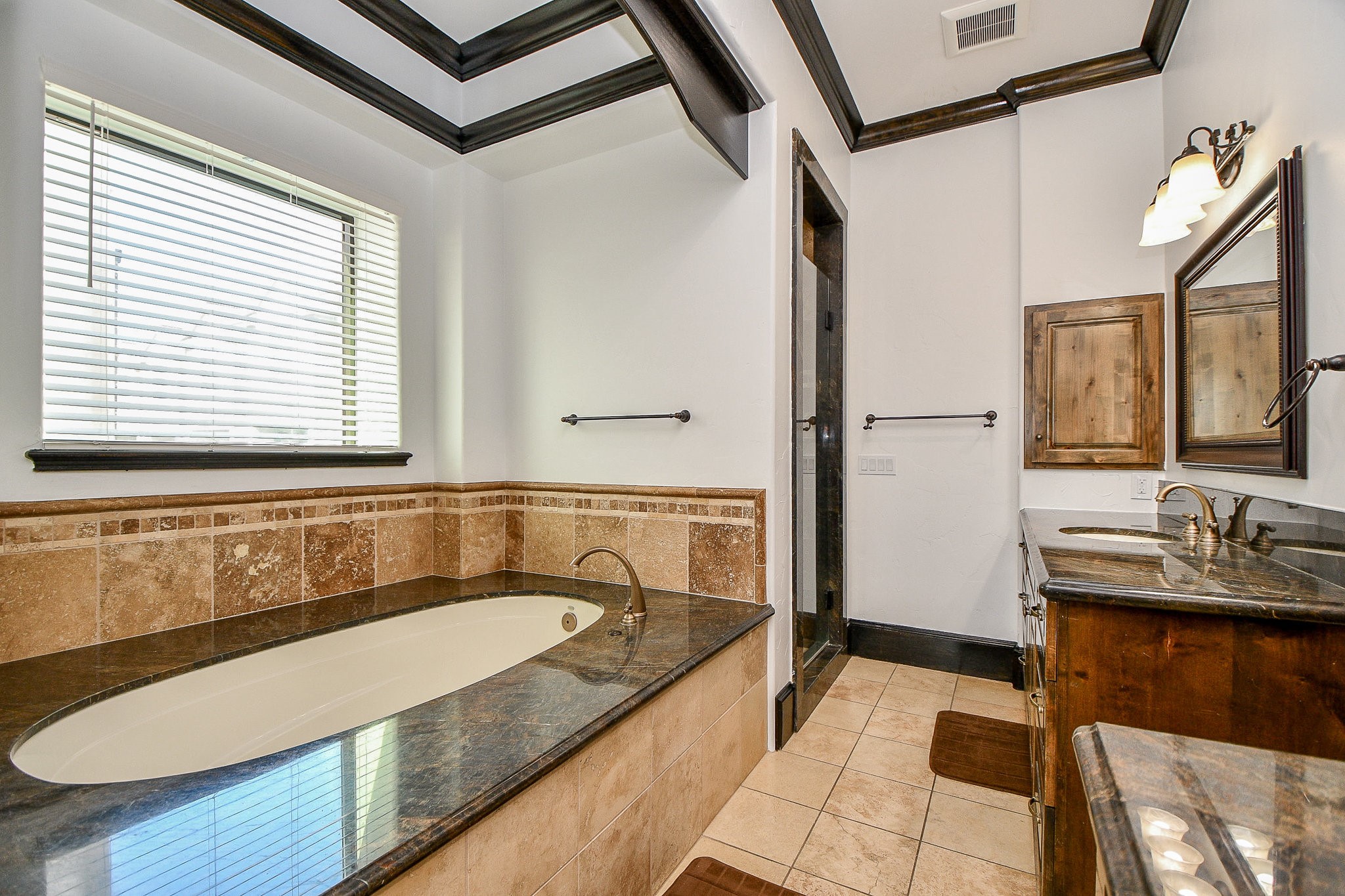 4119 Allen Street Houston, TX 77007 - Photo 44 of 50 a bathroom with a granite countertop tub sink and mirror
