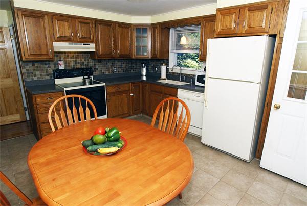 53 Hemenway Road Framingham, MA 01701 - Photo 1 of 27 a kitchen with stainless steel appliances granite countertop a refrigerator a stove a sink a microwave and dining table