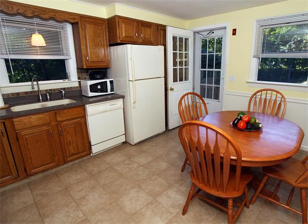 53 Hemenway Road Framingham, MA 01701 - Photo 2 of 27 a kitchen with stainless steel appliances granite countertop a stove a sink a refrigerator a dining table and chairs