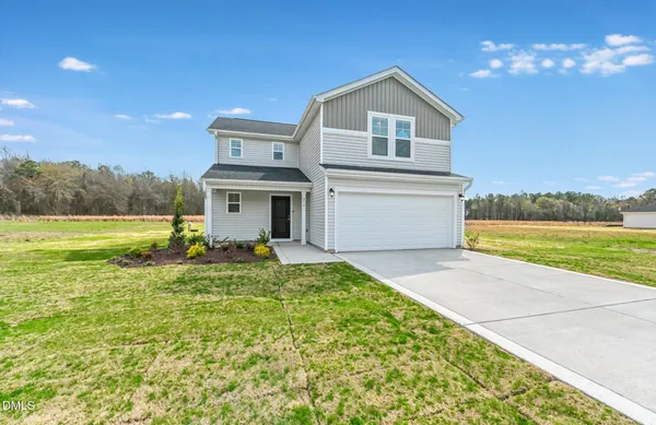 a front view of a house with a yard and garage