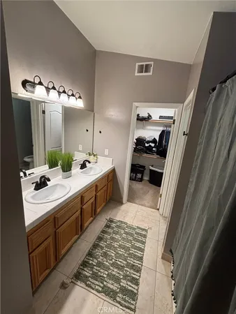 a bathroom with a double vanity sink and mirror