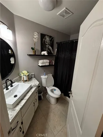 a bed room with a bed and a television