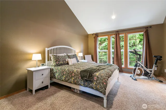 a bedroom with a bed chair and a window