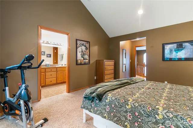 a bedroom with a bed and a view of living room