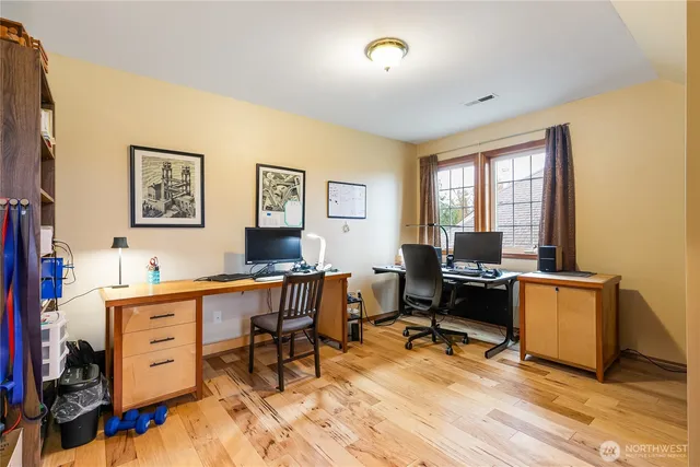 a view of a workspace with furniture and a window